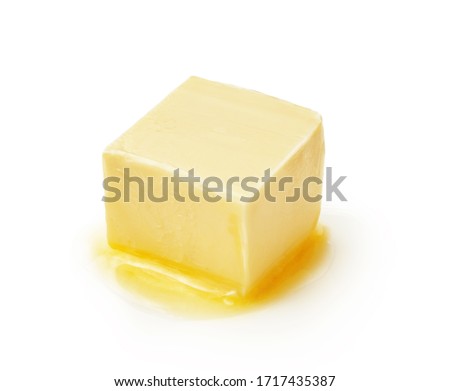 A piece of melting butter isolated on white background. Butter cube.