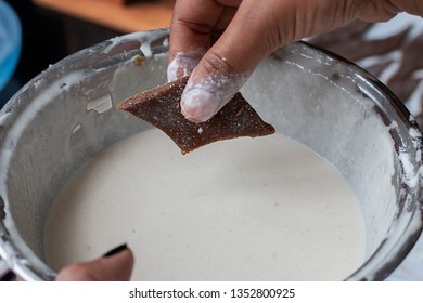 Piece of Mung Ata Kawum (Green Gram Kawum) is ready to dip in Flour batter. Mung Ata Kawum is a Sinhala and Tamil New Year festive food. Also called as Aluth Avurudu/Avurudhu Festival