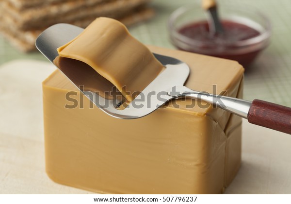  Piece\
of norwegian flotemysost cheese and a\
slicer