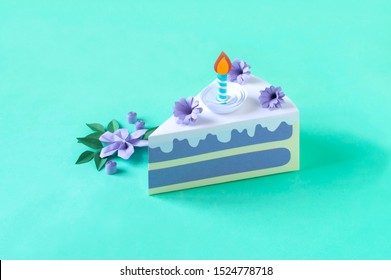 Piece Of Paper Blueberry Cake. Cake Decorated With Purple Paper Flowers And Burning Candle. Volumetric Handmade Paper Objects. Paper Art And Craft. Trendy Hobby. Minimal Art Food Concept