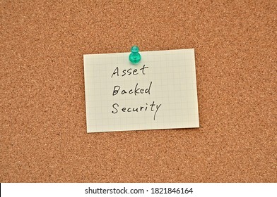 A Piece Of Paper Labeled Asset Backed Security Is Pinned To The Corkboard.