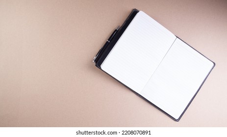 a piece of paper and a pen on the table - Shutterstock ID 2208070891