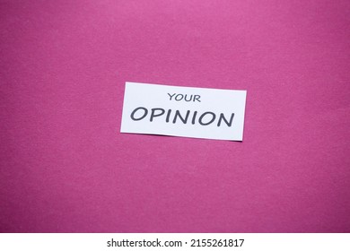 A Piece Of Paper With The Phrase Tu Opinión (Your Opinion) On A Magenta Background.