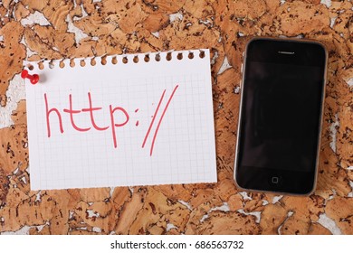 A piece of paper with word http pinned to a cork board and smartphone