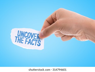 Piece of paper with the word Uncover the Facts with blue background