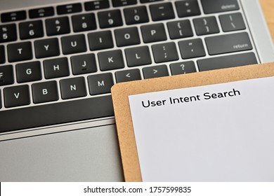 ﻿A piece of paper with the word "User Intent Search" written on it sits on the keyboard. Close up.
 - Shutterstock ID 1757599835