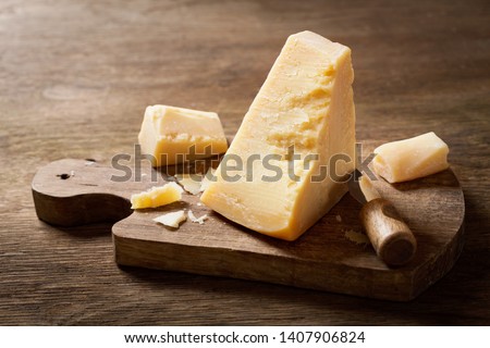 piece of parmesan cheese on a wooden board