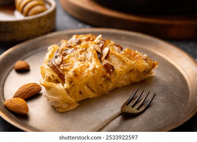 A piece of phyllo pastry pie with pear, gorgonzola cheese, almond and honey close up. High quality photo - Powered by Shutterstock