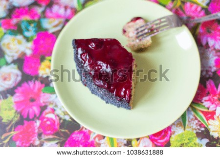 A piece of poppy cherry cake on a plate.