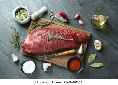 Piece of raw beef meat and spices on grey table, flat lay - Shutterstock ID 2368688551
