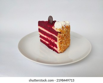 A Piece Of Red Velvet Looks Front On A White Background. With A Sprinkle Of Red Powder And Whipped Cream.