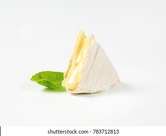piece of soft-ripened cheese with white rind