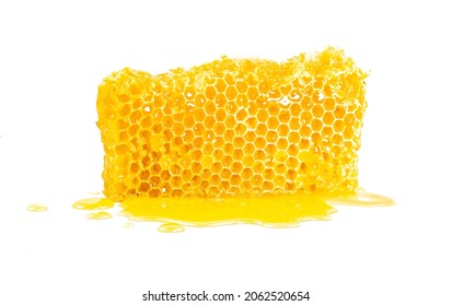 Piece of sweet honeycomb with leaked honey, isolated on white background. Element of packaging design.