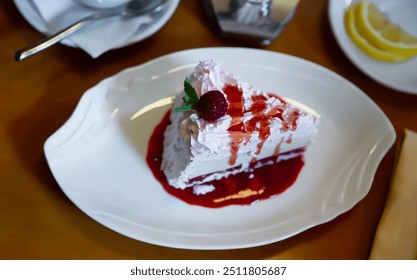 Piece of tasty sweet ice cream cake with berry topping and candied cherry served on white plate - Powered by Shutterstock