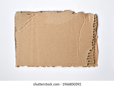 a piece of torn cardboard uneven edge white background