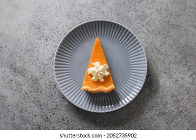 Piece Of Traditional American Pumpkin Pie In Plate On Gray Stone Background. View From Above. Homemade Pastry For Thanksgiving Day.