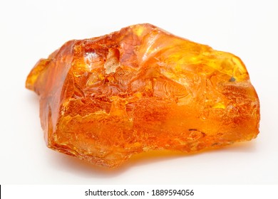 A Piece Of Unique Transparent Yellow Amber On A White Background. A Semi-precious Stone Made From Petrified Resin. Material For Jewelry And Ornaments. Copal. Sun Stone. Fossil Resin. Baltic Gem.