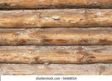 A piece of a wall in a house made of logs. Wood texture is seen distinctly