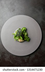 Piece Of White Fish With Brocolli, Greens And Wasabi