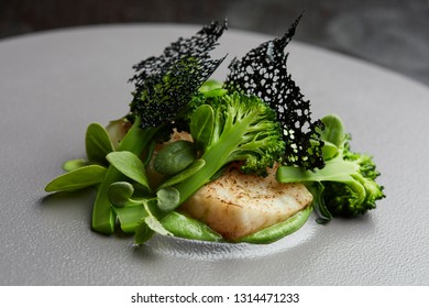 Piece Of White Fish With Brocolli, Greens And Wasabi