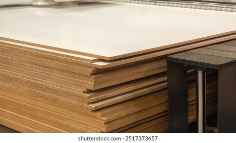 A piece of wood is being cut by a machine. The wood is brown and has a grain pattern - Powered by Shutterstock