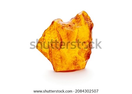 A piece of yellow opaque natural amber classification color Clear Succinite, has superficial cracks on its surface. Placed on white background.