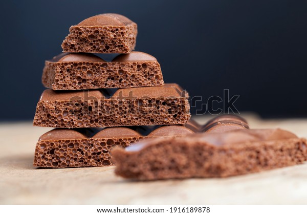 pieces of air chocolate with cocoa and sugar,\
divided into pieces chocolate bar, air milk chocolate broken into\
pieces