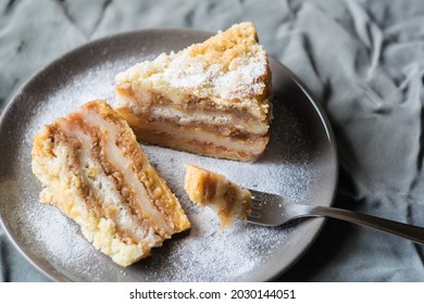 Pieces of apple cake, gateau on a plate on grey tablecloth, selective focus