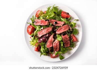 Pieces of beef with fresh lettuce and cherry tomatoes, dressed with olive oil and balsamic cream. - Powered by Shutterstock