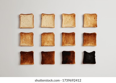 Pieces of bread browned as result of toasting. Delicious crust tender slices of bread prepared in toaster which may be served with spreads or toppings, isolated on white background. Stages of burning.