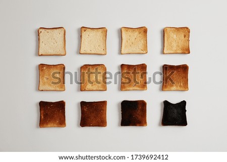 Similar – Image, Stock Photo Toasted toast bread in toaster on pink background