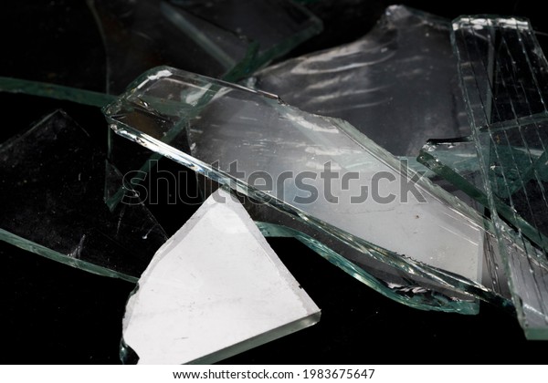 pieces of broken glass on a black background. High\
quality photo