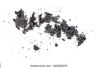 Pieces Of Burnt Paper On A White Background. The Ashes Of The Paper.