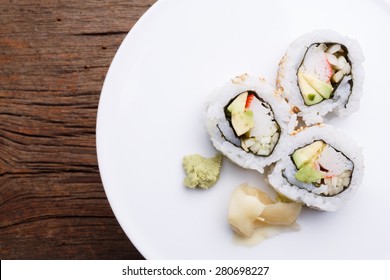 Pieces Of California Roll Sushi On A White Plate.