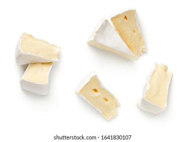 Pieces of camembert cheese isolated on white background. Flat lay. Top view