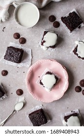 Pieces Of Chocolate Brownie With White Icing Top Down View