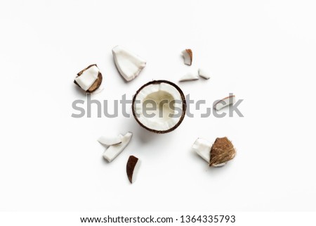 Pieces of coconut on white background, top view