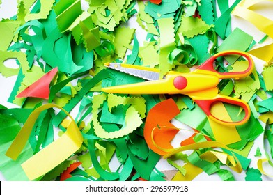 Pieces of colored paper that sliced baby. Cut colored paper and scissors.