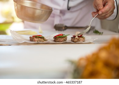 Pieces Of Cooked Meat. Male Hand With A Spoon. Delicious Medallions With Roquefort Sauce. Dinner For A Gourmet.