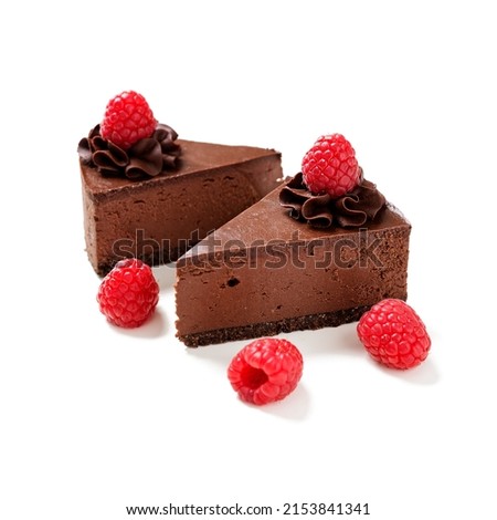 Pieces of Creamy dark chocolate cheesecake with chocolate Oreo biscuits and raspberries. isolated on white background