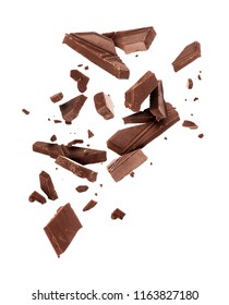 Pieces of dark chocolate falling close up on a white background - Shutterstock ID 1163827180