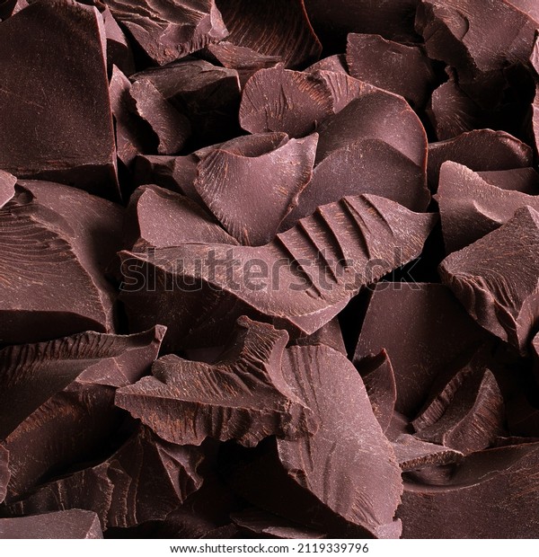 pieces of dark chocolate, sweet food background. broken chocolate for dessert as snack.