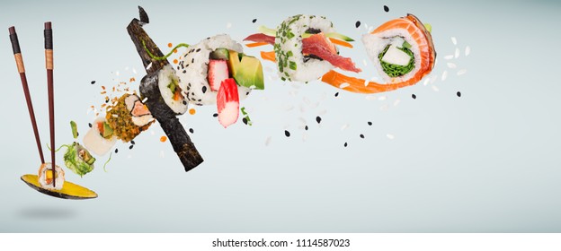 Pieces of delicious japanese sushi frozen in the air on pastel color background. - Powered by Shutterstock