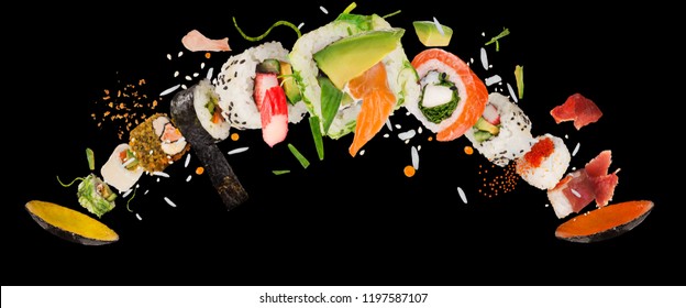 Pieces of delicious japanese sushi frozen in the air. Isolated on black background