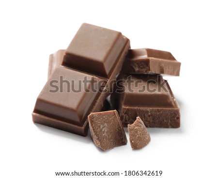 Pieces of delicious milk chocolate isolated on white