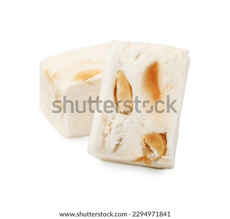 Pieces of delicious nougat on white background