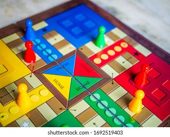 Pieces And A Die On A Ludo Board Game