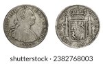 "Pieces of eight". Front and back of Spanish 8-reale silver dollar minted in Mexico in 1797.Worn, tarnished, battered, struck off-center. Was legal tender in most of world (including USA until 1857).