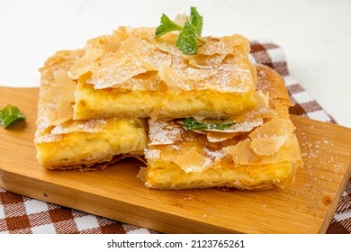 Pieces Of Filo Pastry Pie On A Wooden Board.