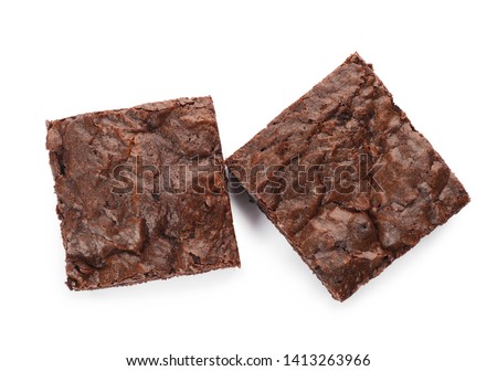Pieces of fresh brownie on white background, top view. Delicious chocolate pie